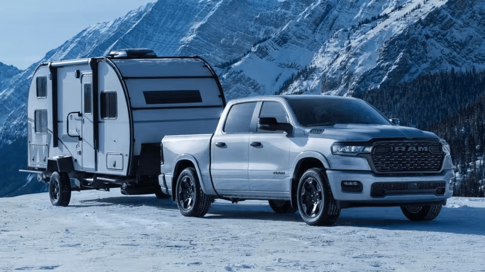 Ram 2500 towing a trailer on a snow-covered road