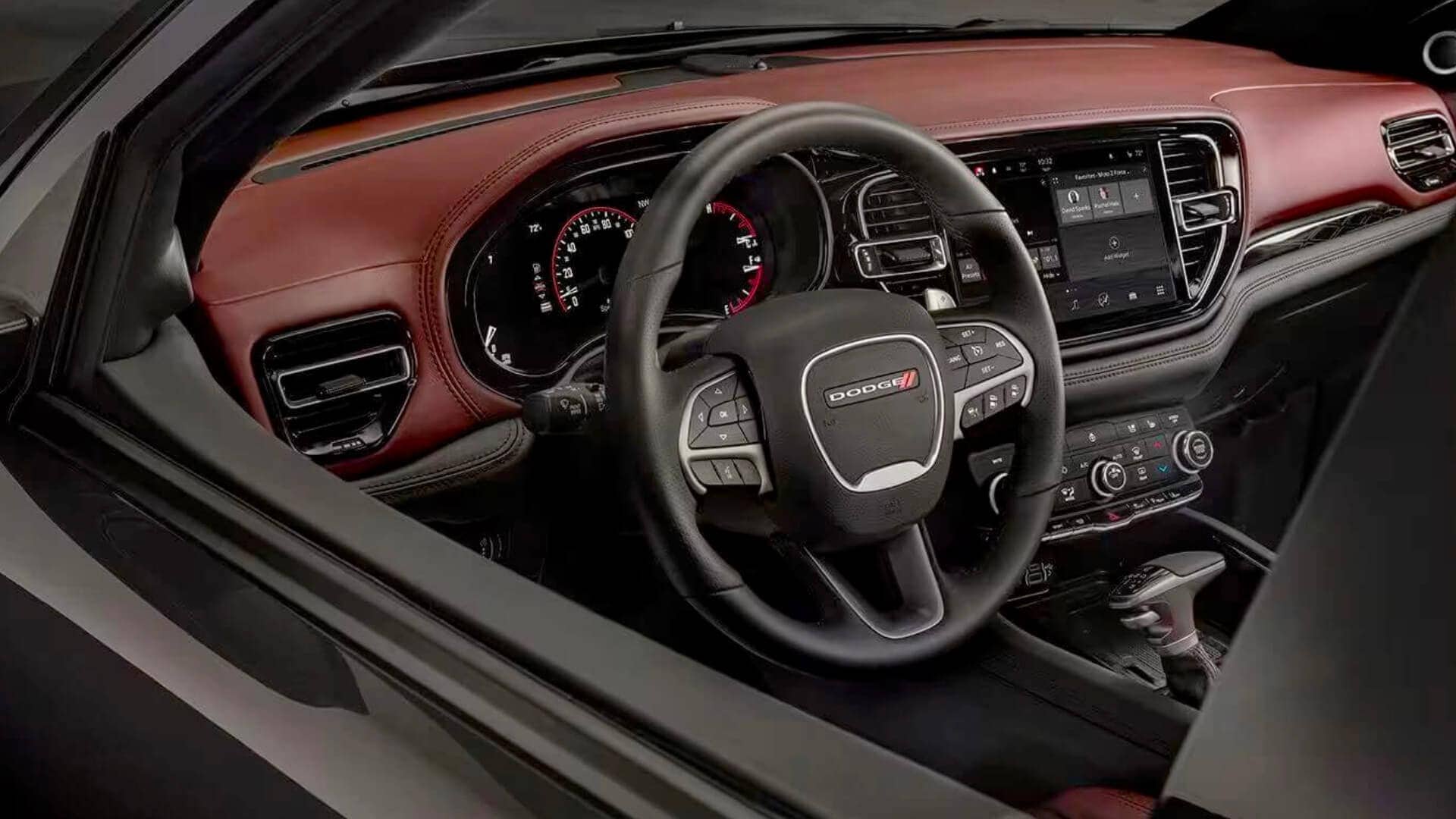 Interior shot of the 2023 Dodge Durango showing the steering wheel and dashboard controls.