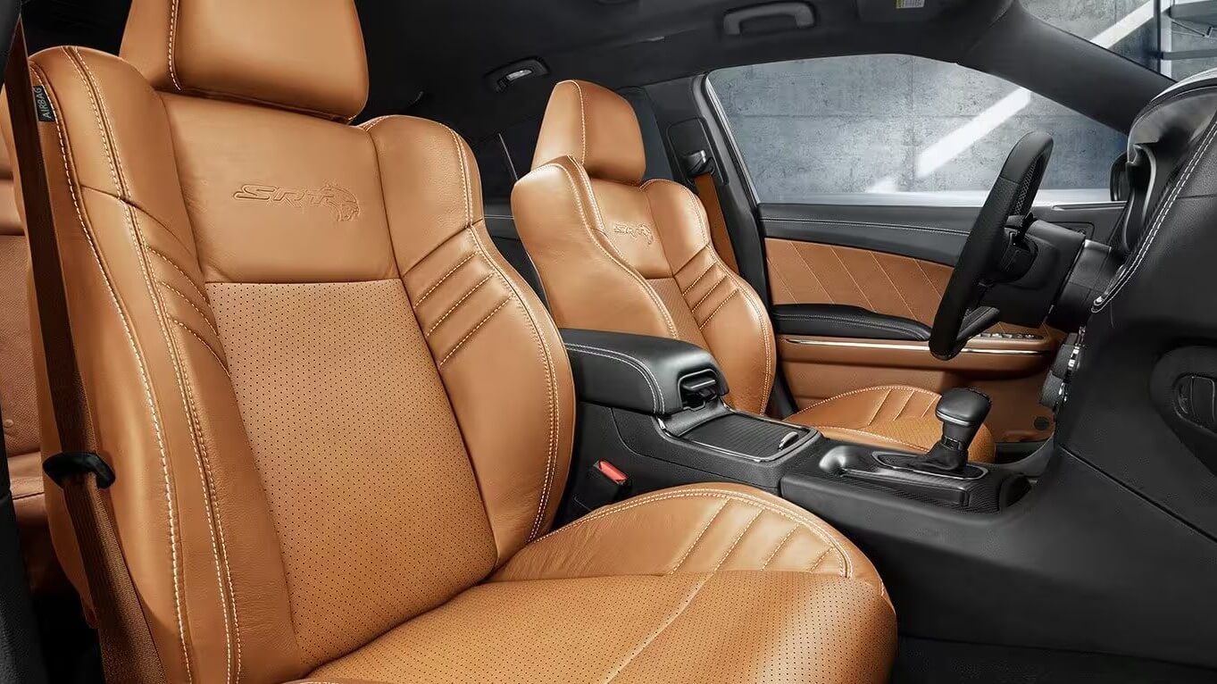 Learn which Dodge models feature heated and cooled seats, like the Dodge Charger. Interior shot of the Dodge Charger, showing the front seats, which can have heated and cooled seats based on trim and add-on package availability.