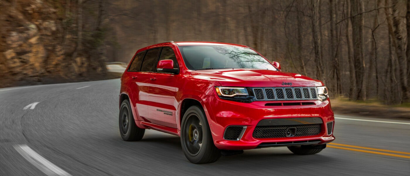 New Jeep Grand Cherokee driving through the woods