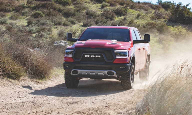 2023 Ram 1500 driving on a dirt road