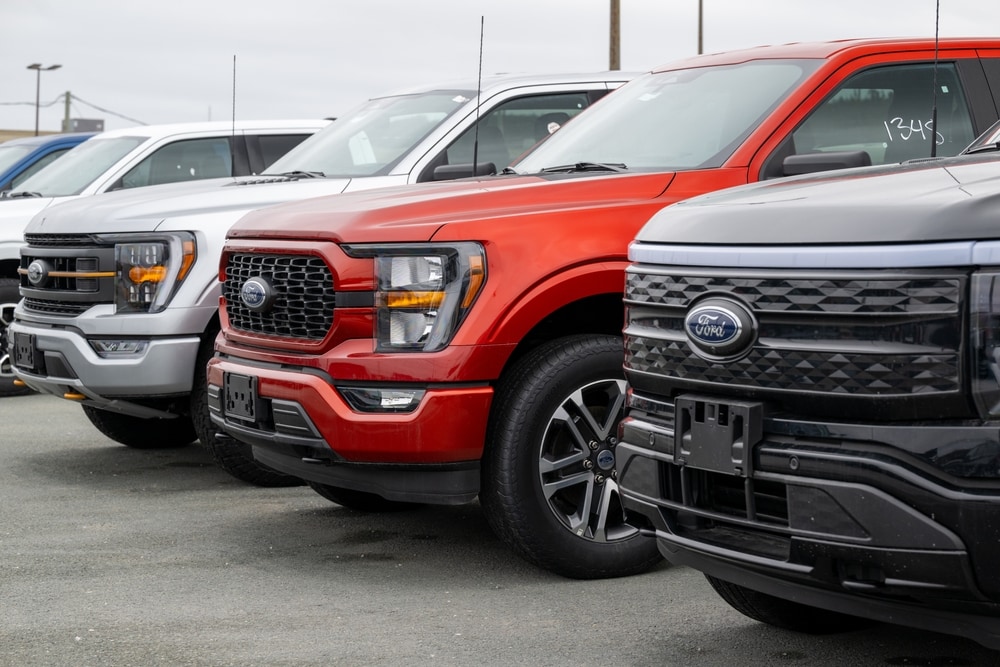 Row%20of%20new%20Ford%20pickup%20trucks%20in%20various%20colors%20parked%20at%20a%20dealership%20lot.jpg