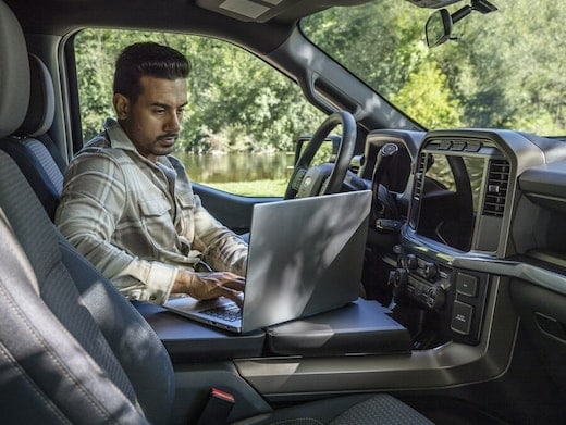Man driving a 2025 Ford F-150® King Ranch® showing the center stack display screen