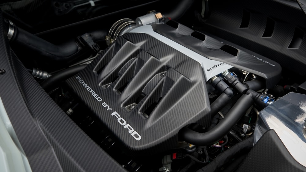 Close-up%20of%20a%20car%20engine%20showing%20the%20Powered%20by%20Ford%20label%20on%20the%20engine%20cover%2C%20with%20visible%20pipes%20and%20components.jpg
