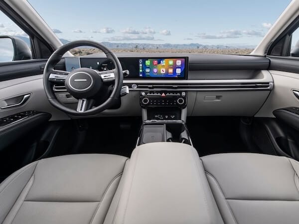 2026 Hyundai Tucson interior featuring panoramic digital displays and spacious front cabin