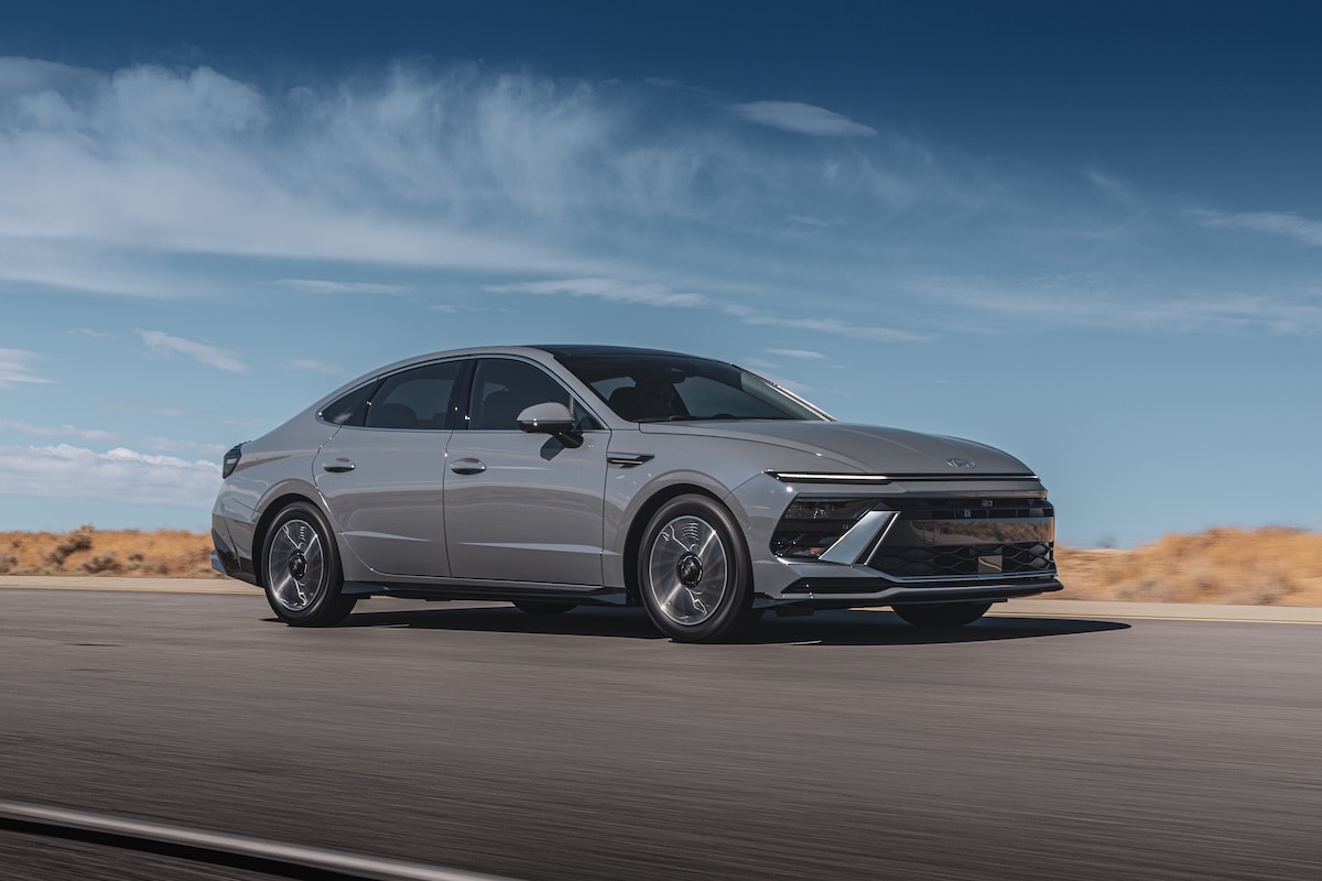 Silver Hyundai Sonata Hybrid driving on an open road