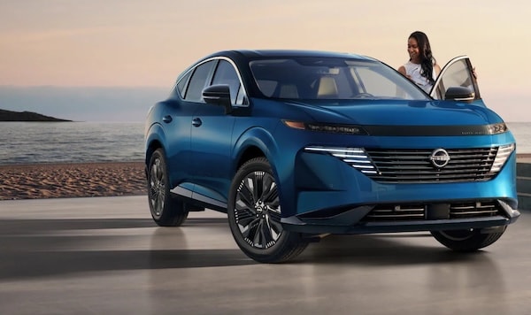a blue 2026 Nissan Murano parked in front of a body of water