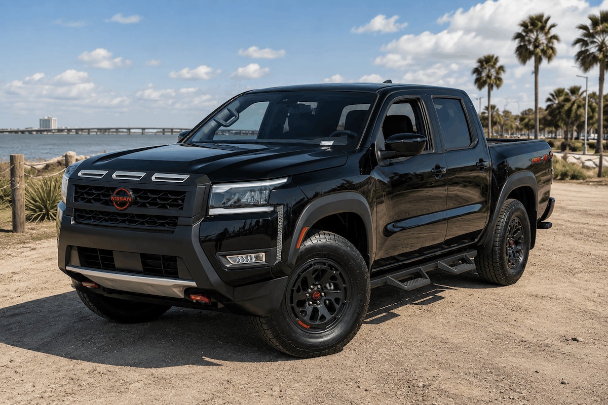 Black 2026 Nissan Frontier PRO-X Crew Cab shown from the front three-quarter view
