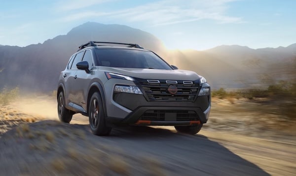 2026 Nissan Rogue driving on a rugged road, a great family SUV option near Gulfport, Mississippi