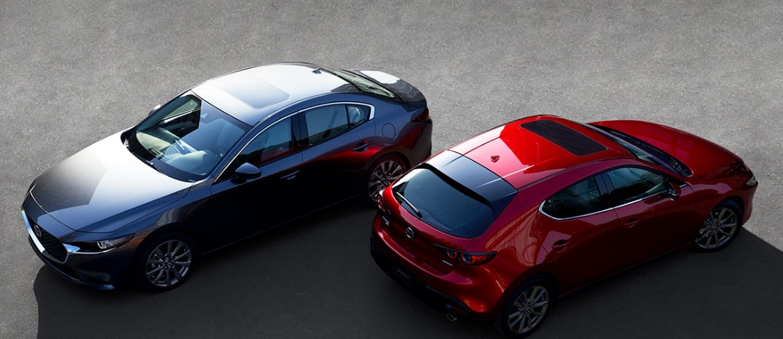 Benefits of Changing Your Mazda's Oil at Mazda of New Bern in New Bern | Black 2020 Mazda6 and red 2020 Mazda3 parked facing opposite directions