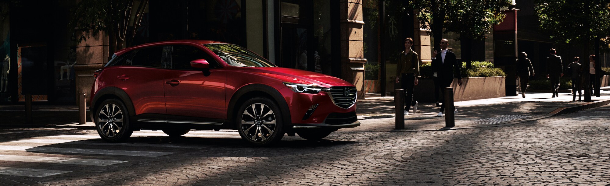 Mazda of New Bern is a car dealership near Pine Knoll Shores NC | Red 2020 Mazda CX-5 parked on cobblestone road