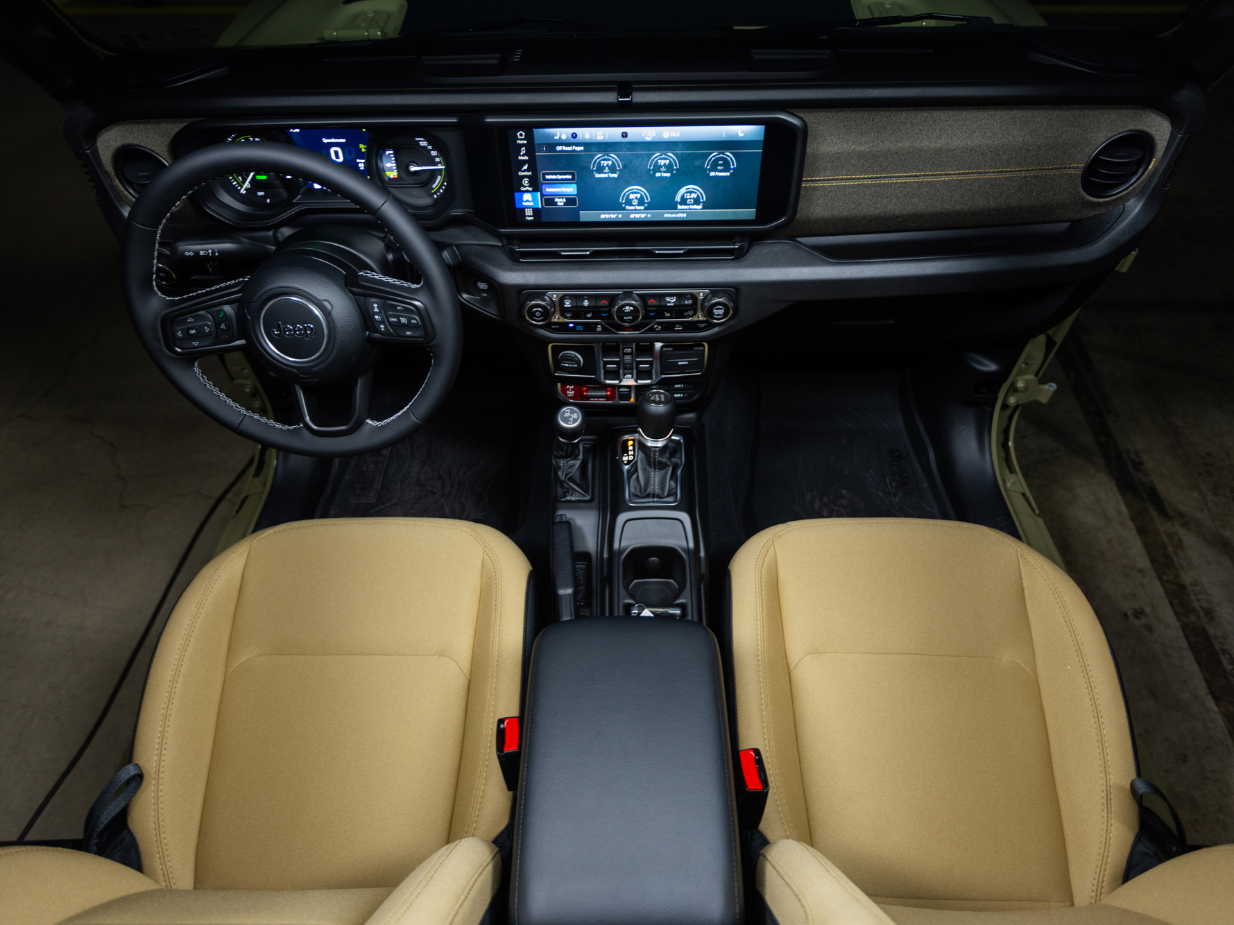Experience the rugged yet comfortable 2027 Jeep Wrangler cabin with seating for up to five premium leather options 12 way power heated front seats and a digital cluster displaying key off road data