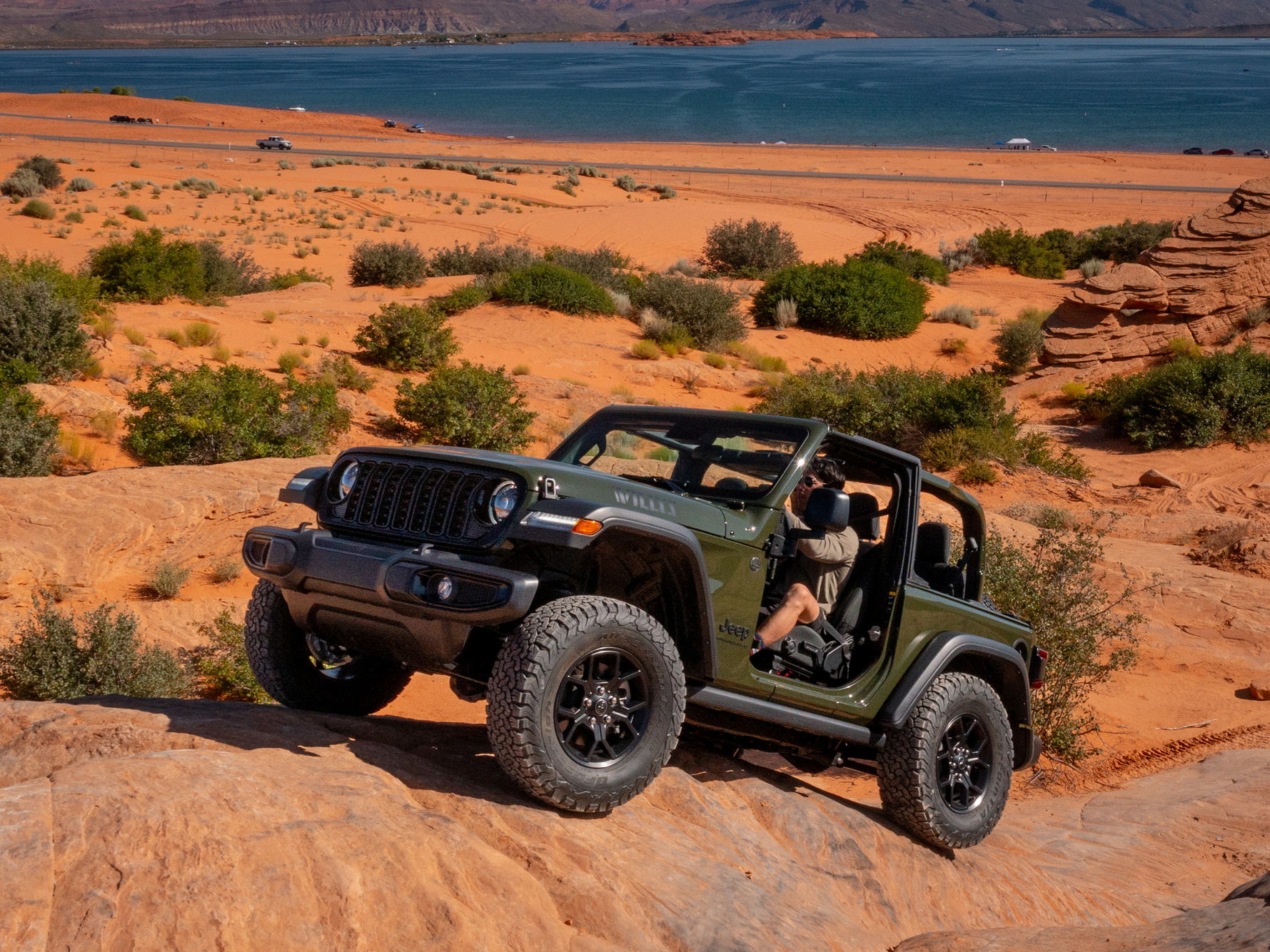 The iconic 2027 Jeep Wrangler silhouette featuring a seven slot grille removable doors flexible soft or hard top choices and rugged wheel options up to 35 inch tires