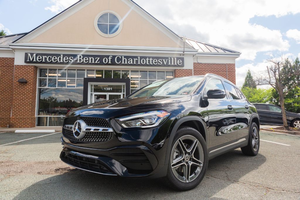 Black Mercedes-Benz sedan car outside dealership, Mercedes-Benz of Charlottesville, near Richmond VA