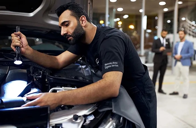 technician performing Mercedes-Benz service inspection