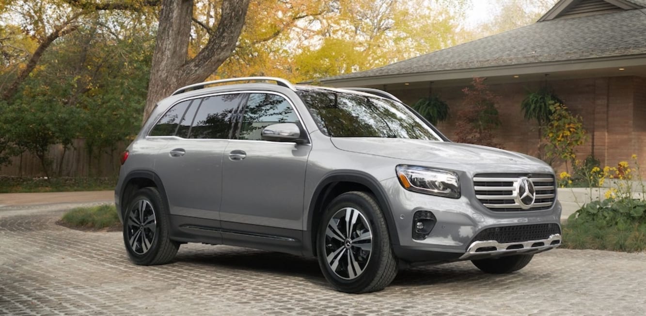 A silver Mercedes-Benz GLB SUV parked outside a house