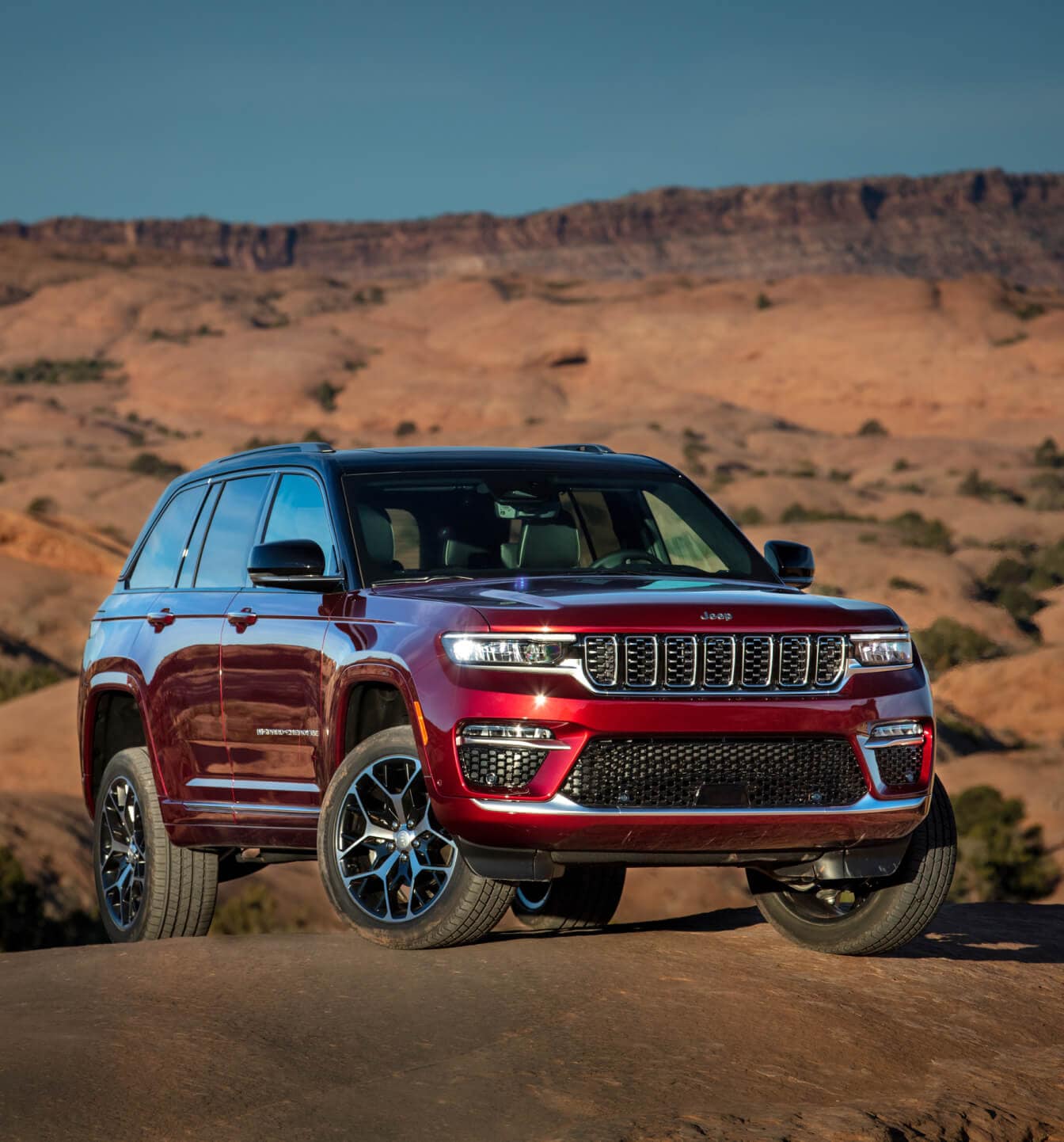 Front three-quarter view of a 2025 Jeep Grand Cherokee in Velvet Red Pearl