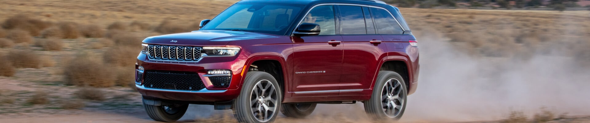 Jeep Grand Cherokee in Velvet Red Pearl driving in the desert