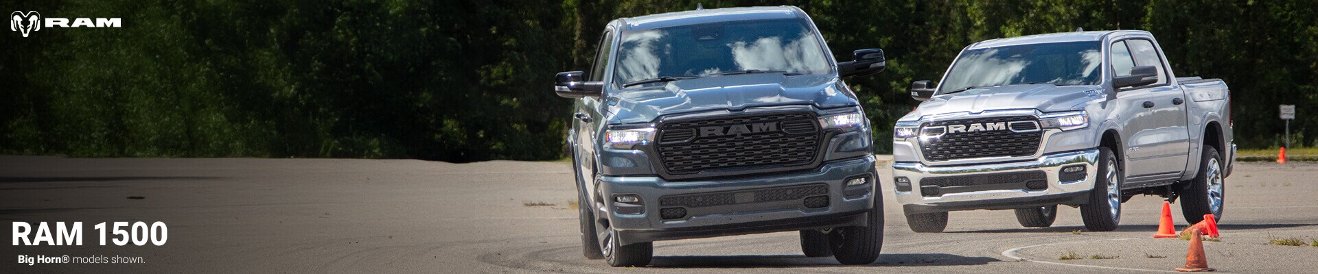 Two 2026 Ram 1500 Big Horn Trucks driving in a parking lot, one in Billet Silver & another in Silver Zynith