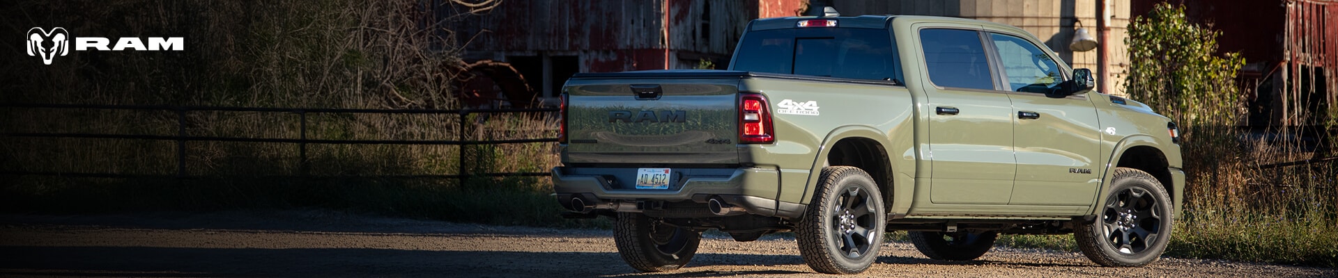 2026 Ram 1500 Big Horn in Serrano Green parked in front of a silo
