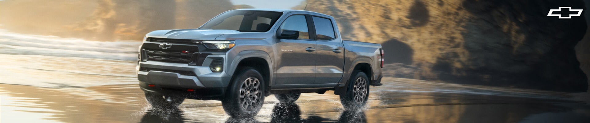 2026 Chevrolet Colorado Z71 in Gray driving on a wet road
