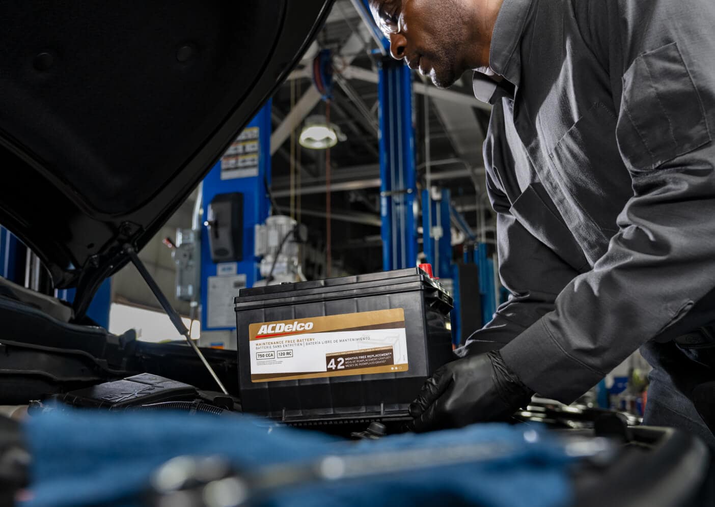 Chevy service technician replacing a car battery