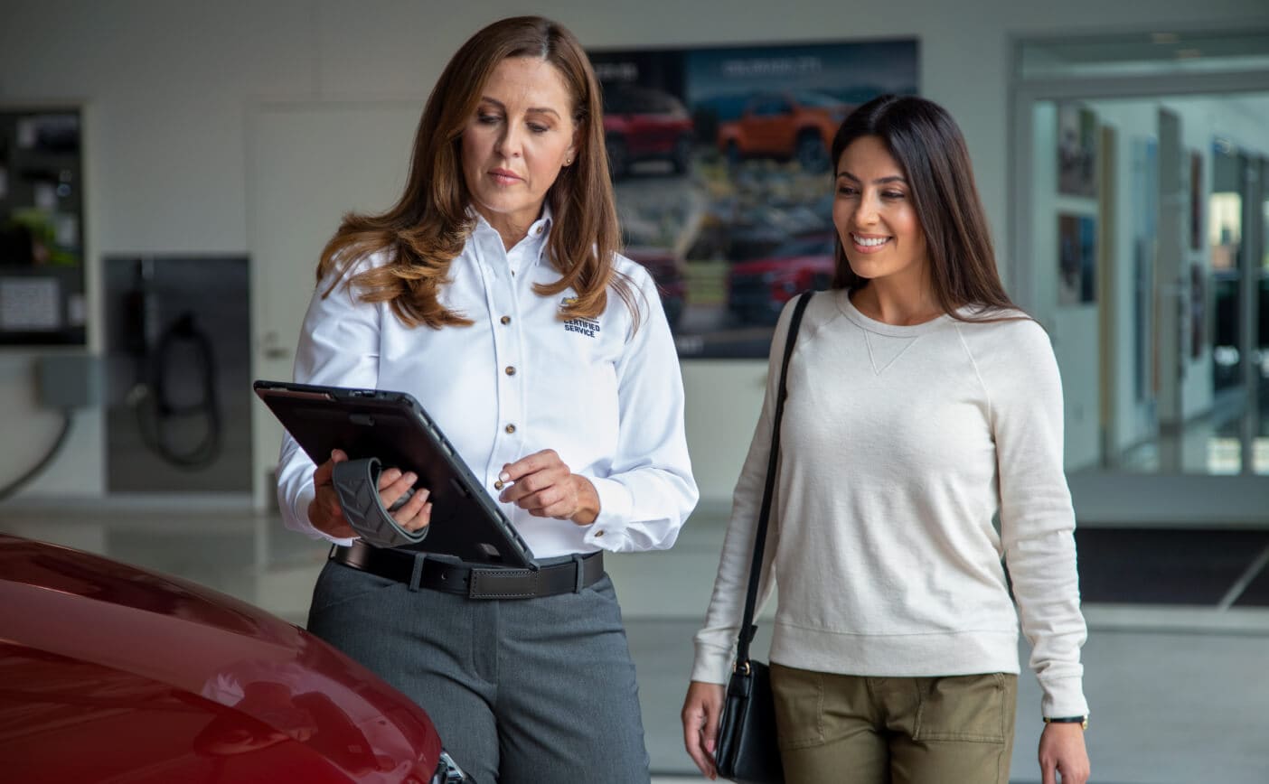 Chevy customer being shown the results of a multi-point inspection on a tablet