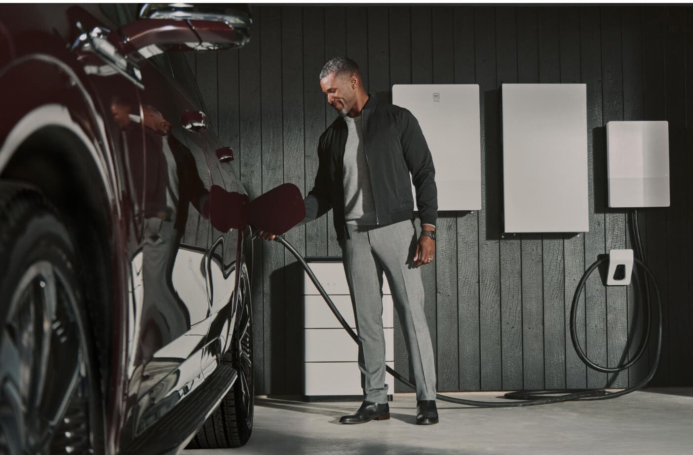 A man charging his Chevrolet EV in his garage