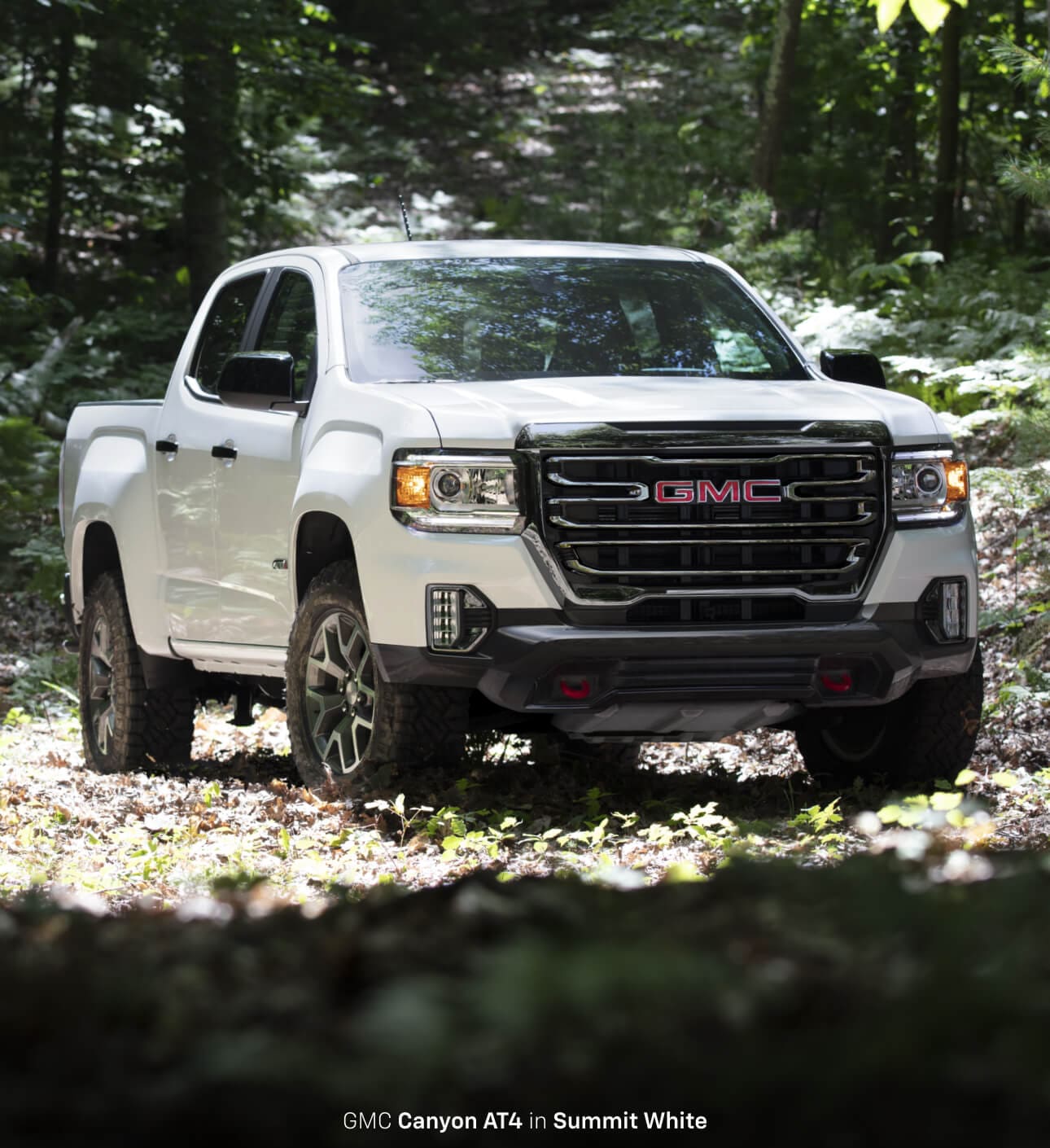 2022 GMC Canyon AT4 in Summit White parked in the woods