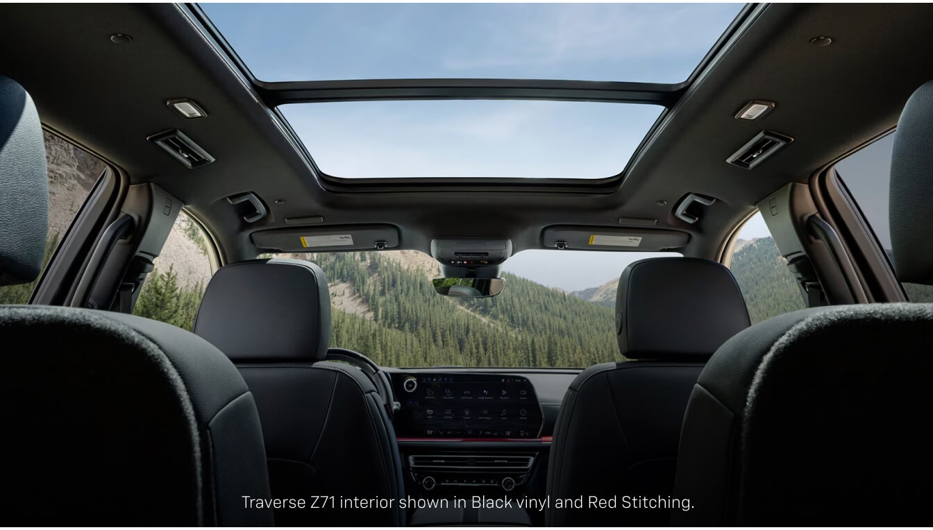 Interior view of a Chevrolet Traverse Z71 highlighting a panoramic sunroof with a view of a valley.