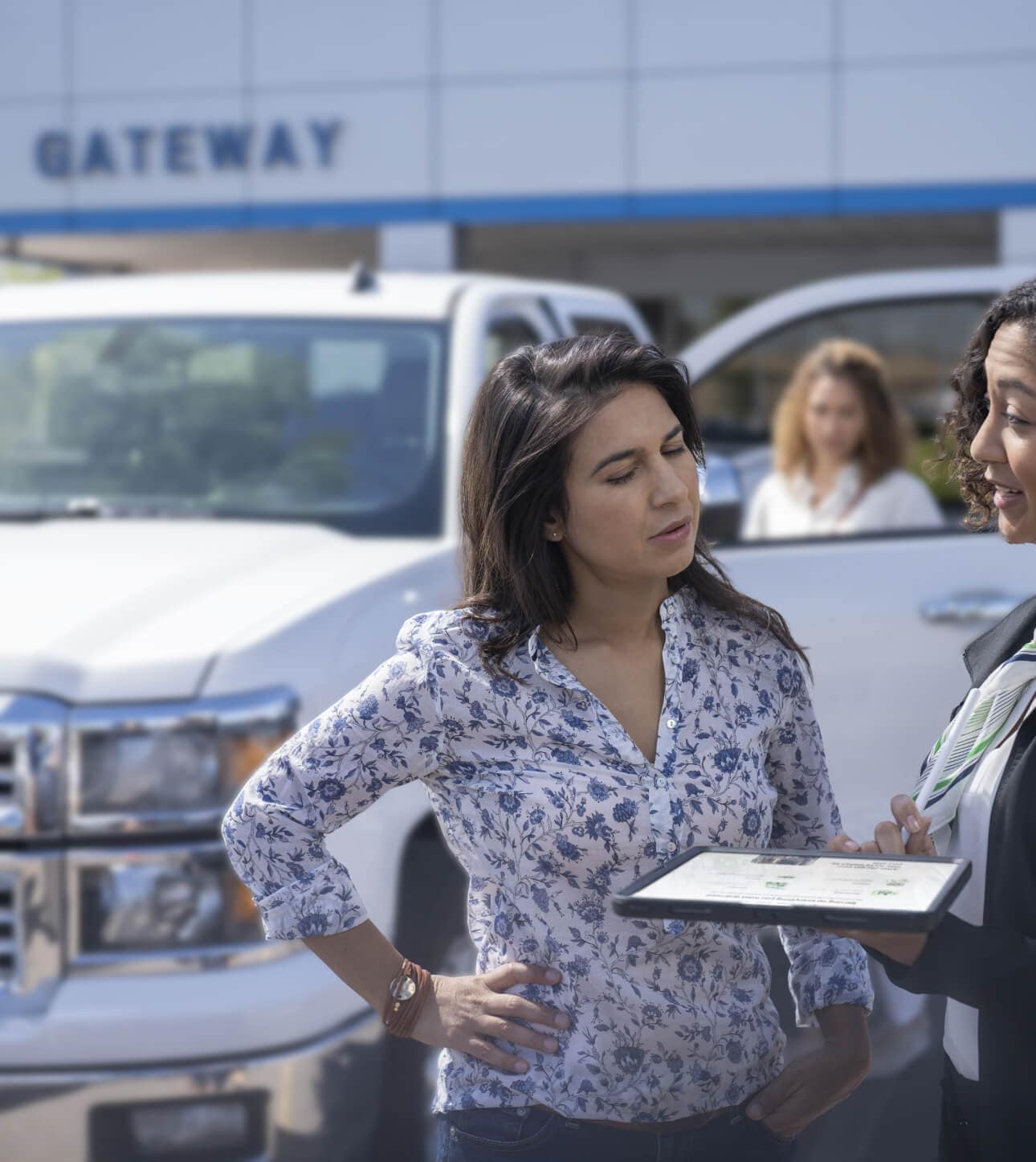 2022 Chevy Silverado 1500 in Summit White parked outside a dealership during a sales event