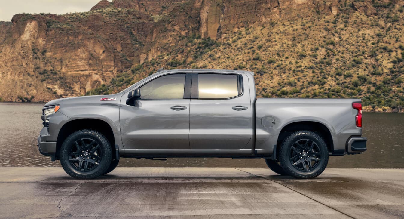 Chevy Silverado 1500 Crew Cab / LT in Sterling Gray Metallic parked in front of a dessert terrain