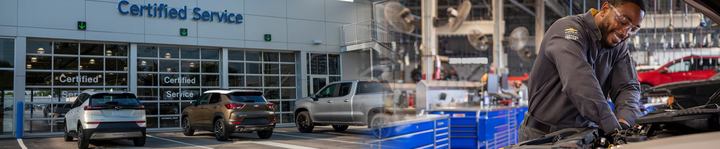 A Chevy Service Center and a Chevy Certified Service technician working under a car's hood.