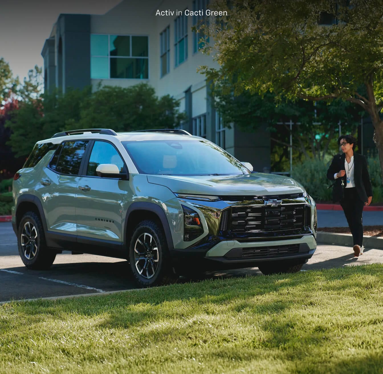 Woman exiting her 2026 Chevy Equinox Activ in Cacti Green