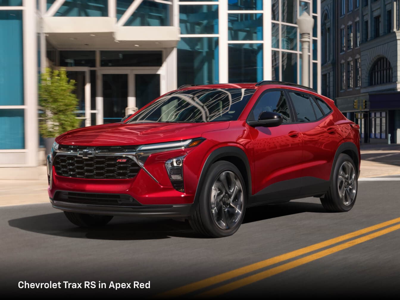 2026 Chevrolet Trax RS in Apex Red on a sunlit street