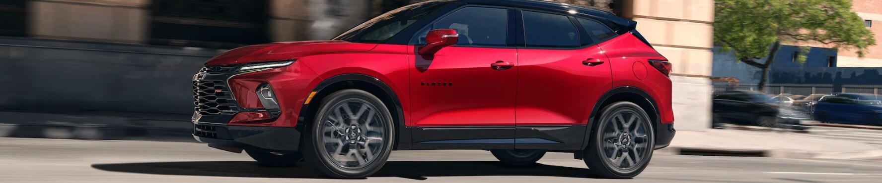 2026 Chevy Blazer RS in Red driving through a city