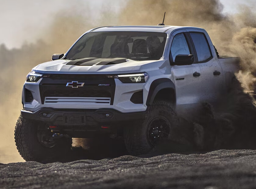 2025 Chevrolet Colorado ZR2 4WD in Summit White Off-Roading, kicking up dirt in its path