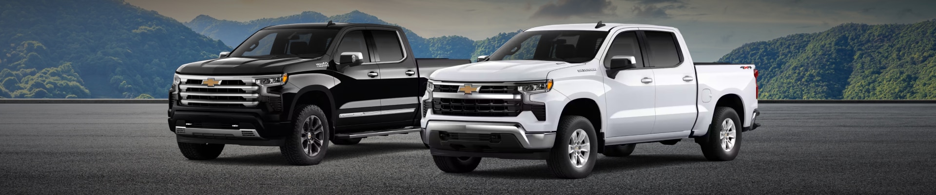 2026 Chevy Silverado 1500 Trucks parked side-by-side in front of mountainous terrain