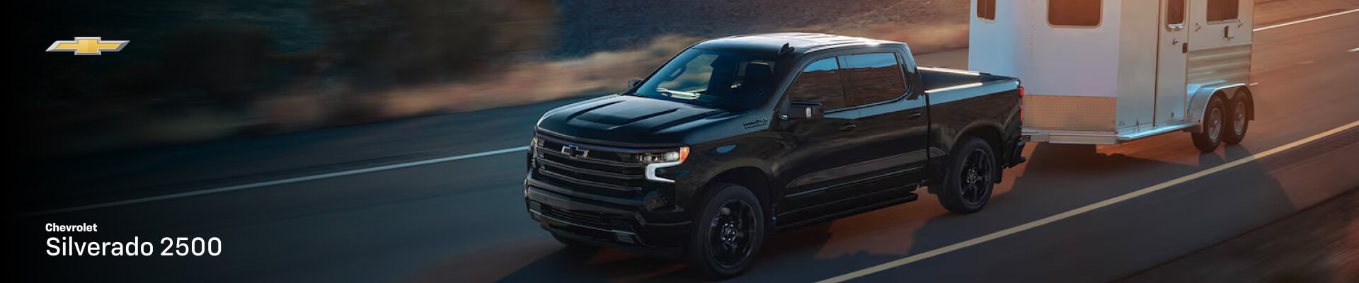 2026 Chevrolet Silverado 2500 High Country towing a small trailer on a highway
