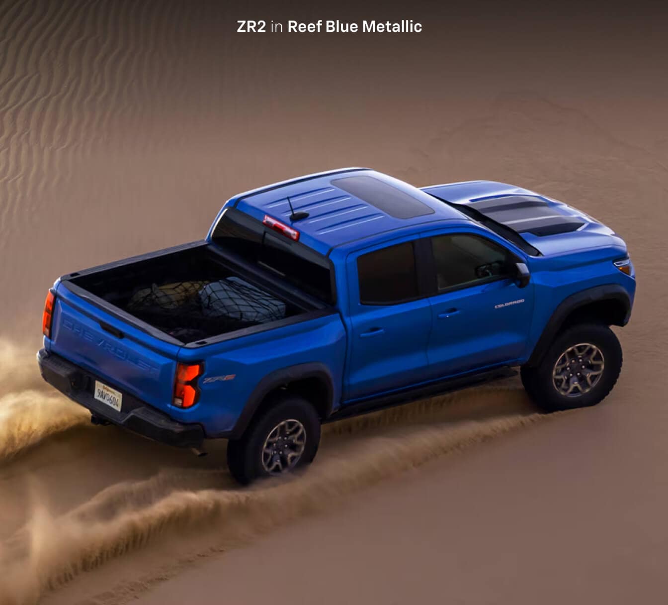 2026 Chevrolet Colorado ZR2 in Reef Blue Metallic driving in a desert