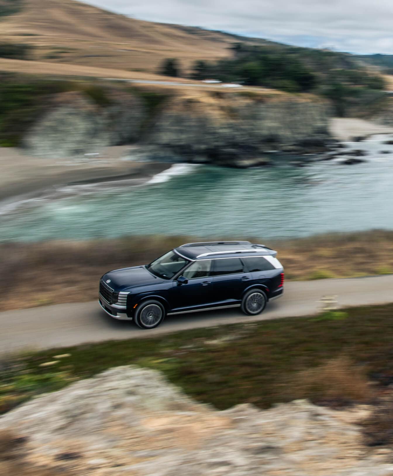 2026 Hyundai Palisade driving past a small body of water