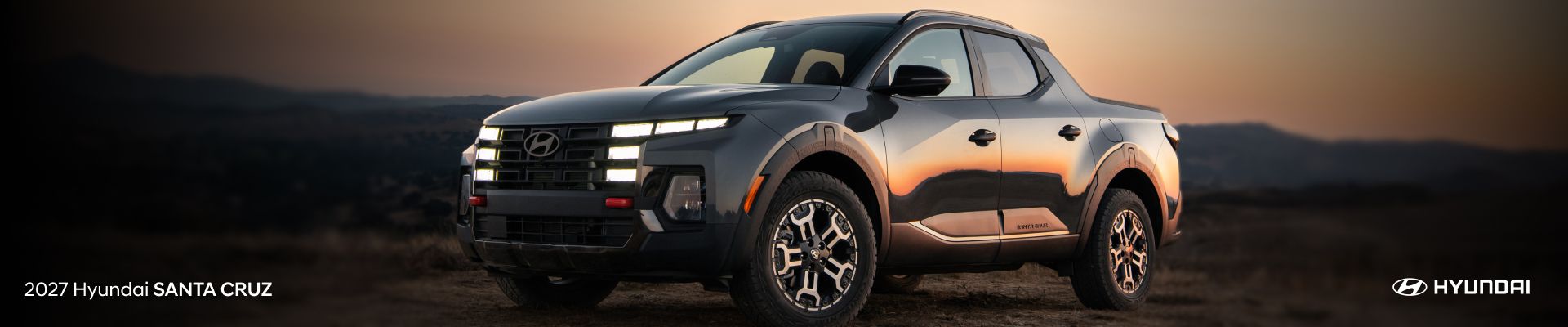 2027 Hyundai Santa Cruz parked outdoors at sunset with its LED lights illuminated.