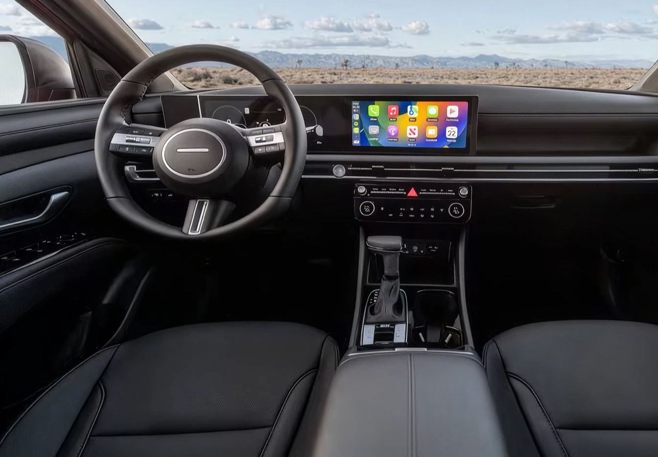 Interior view of a Hyundai Santa Cruz featuring the steering wheel, digital displays, center console, and infotainment touchscreen.