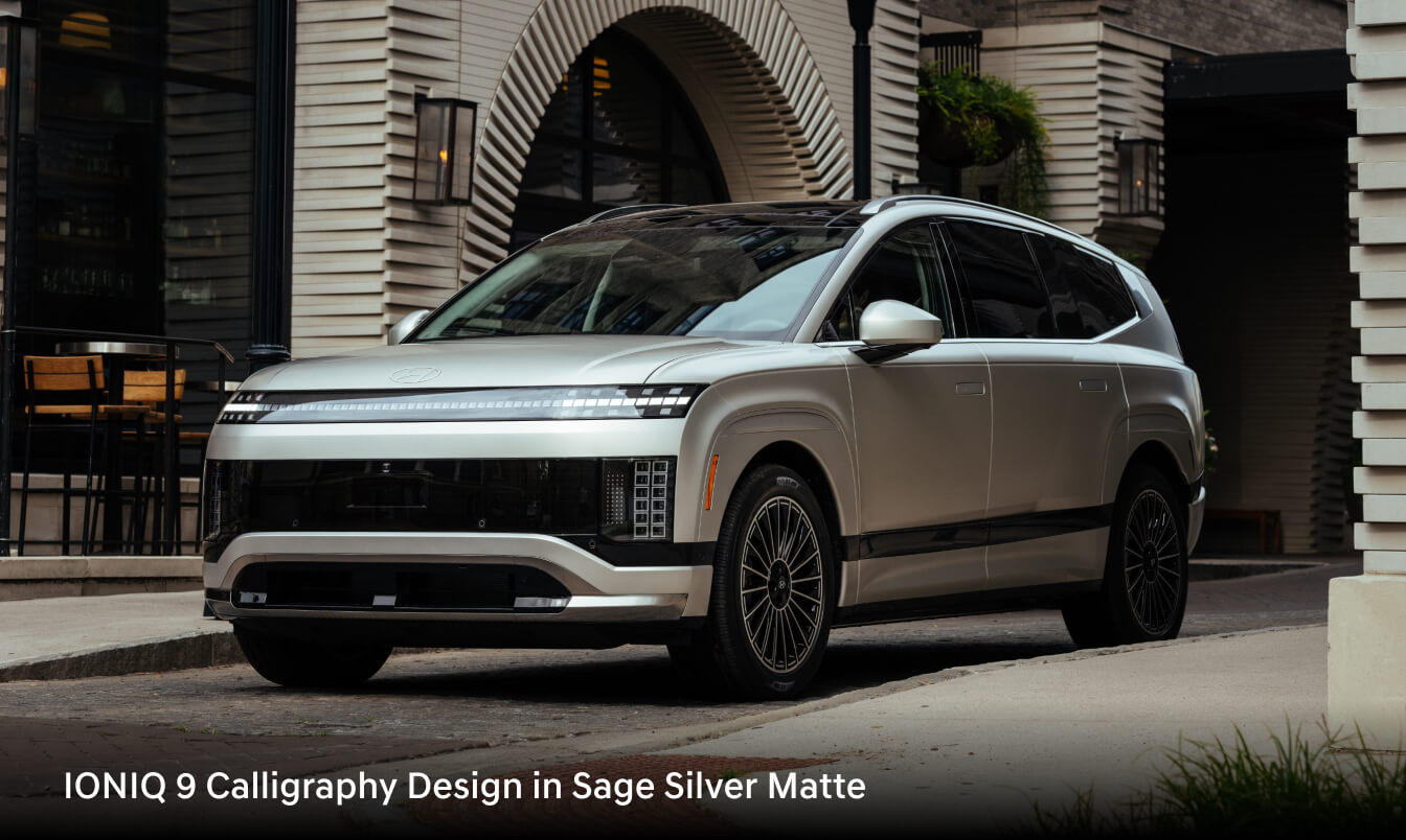 2026 IONIQ 9 Calligraphy Design in Sage Silver Matte parked outside an arched architectural feature