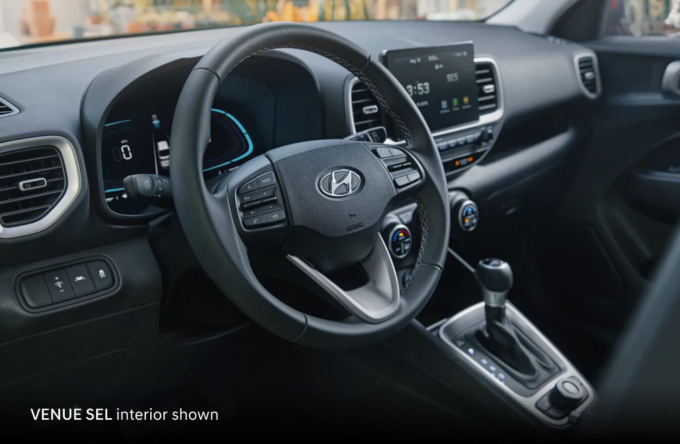 2026 Hyundai Venue SEL with black interior, showing the steering wheel, digital cluster and infotainment screen.