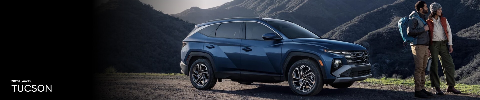 2026 Hyundai Tucson Limited in Atlantis Blue parked in front of a hilly landscape