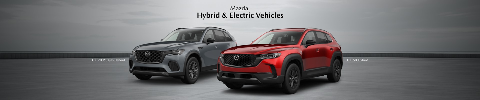 Mazda CX-70 Plug in Hybrid in Gray & CX-50 Hybrid in Red with a gray backdrop, the words Mazda Hybrid & Electric Vehicles floating overhead