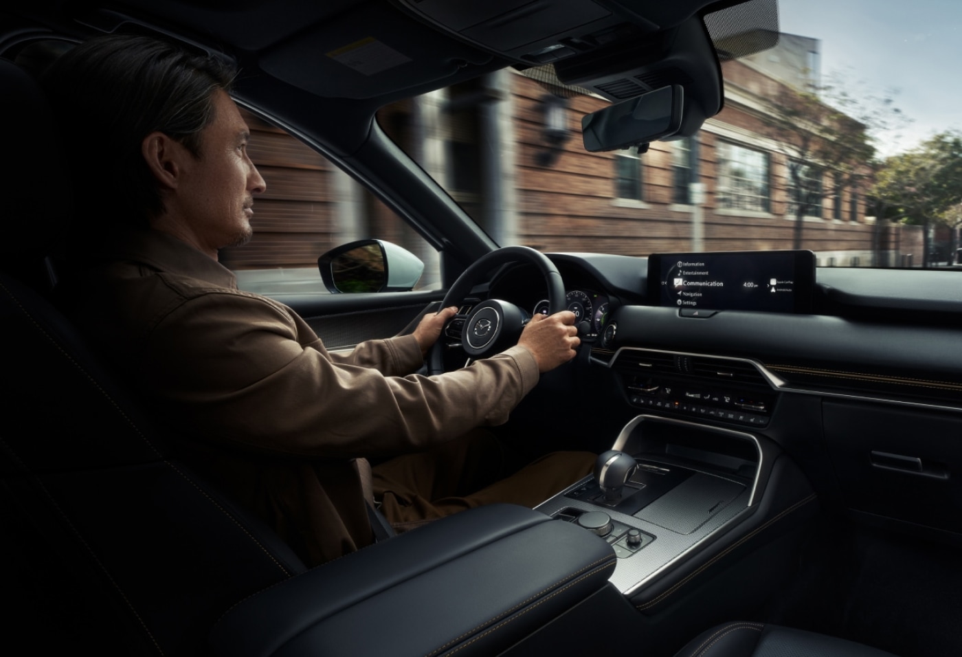 Interior shot of a man driving his 2026 Mazda CX-90 SUV