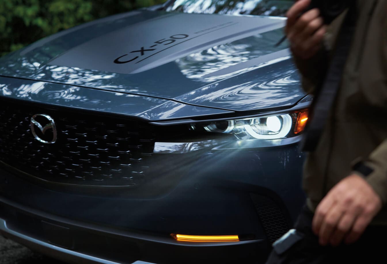 Close-up of the front and hood of a Mazda CX-50 in Polymetal Grey Metallic