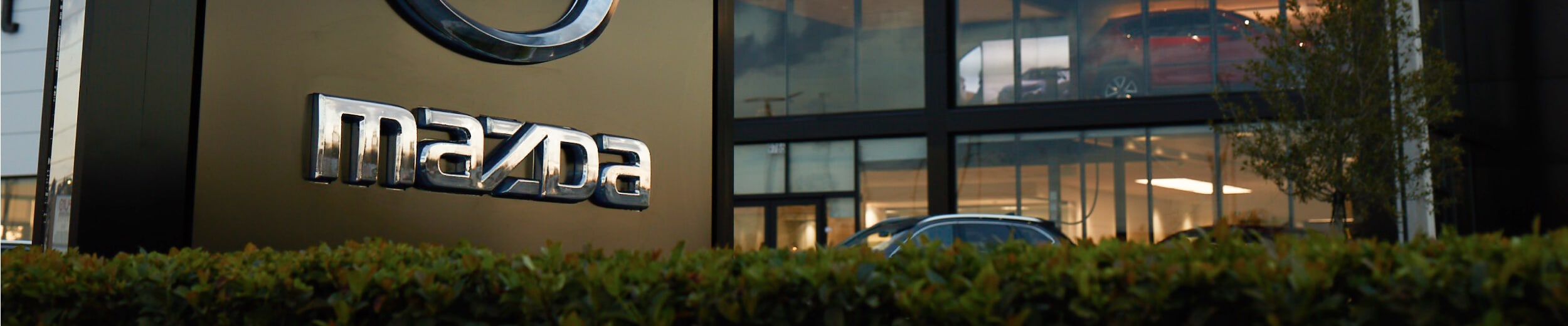 Close-up of the Mazda logo signage at a Mazda dealership near Rutland, Vermont
